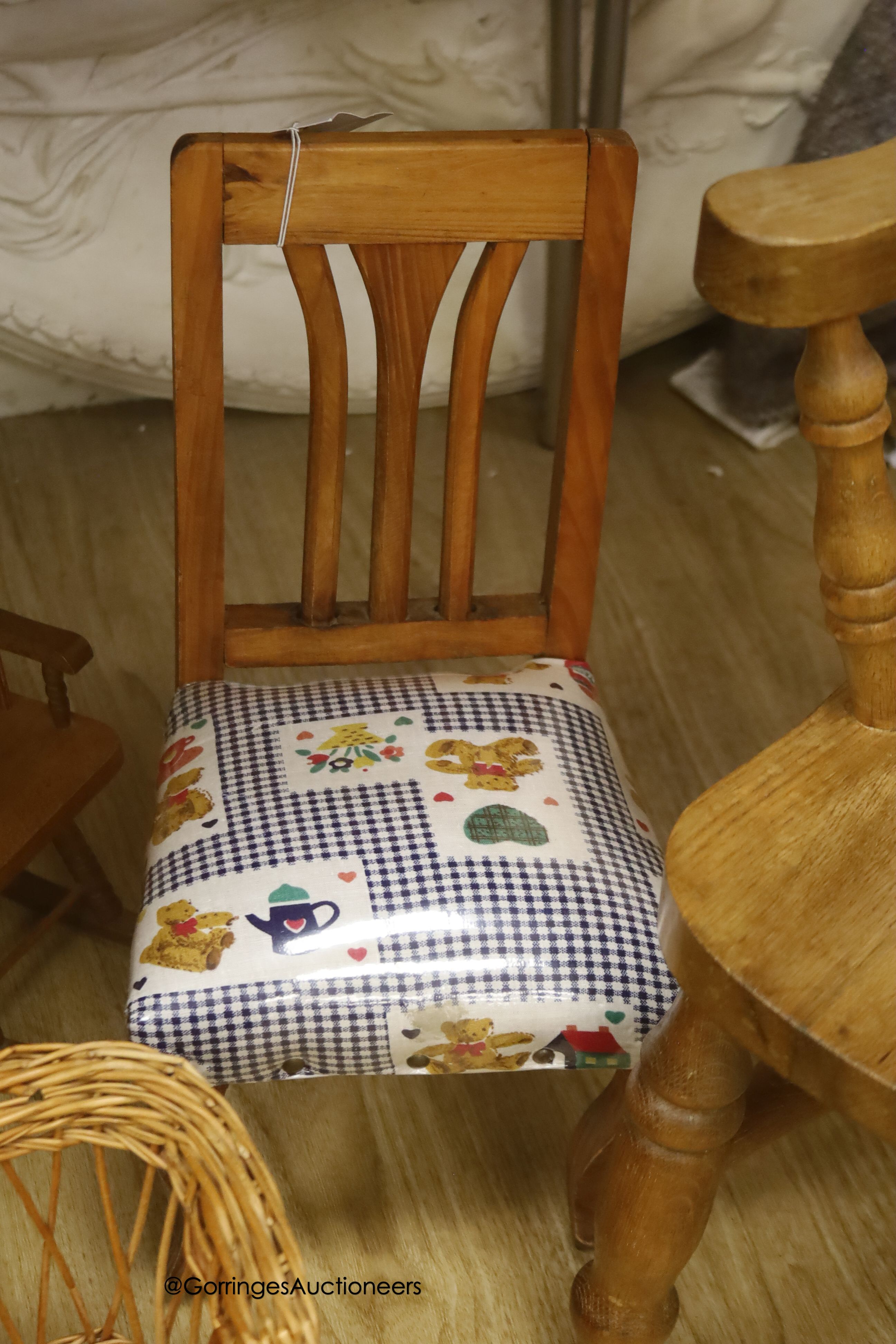 A wicker settle and six wicker chairs for display, together with a child's modern Windsor chair and two wooden chairs